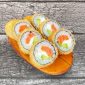 Assorted tempura sushi rolls with crispy outer layer, containing fillings of salmon, avocado presented neatly on a wooden plate.